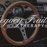 Car dashboard with a steering wheel and instrument panel, overlaid with text 'Legacy Trails Therapy LLC'.