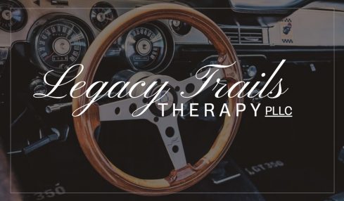 Car dashboard with a steering wheel and instrument panel, overlaid with text 'Legacy Trails Therapy LLC'.