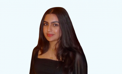 Portrait of a woman with long dark hair wearing a black top, smiling slightly, against a light background.